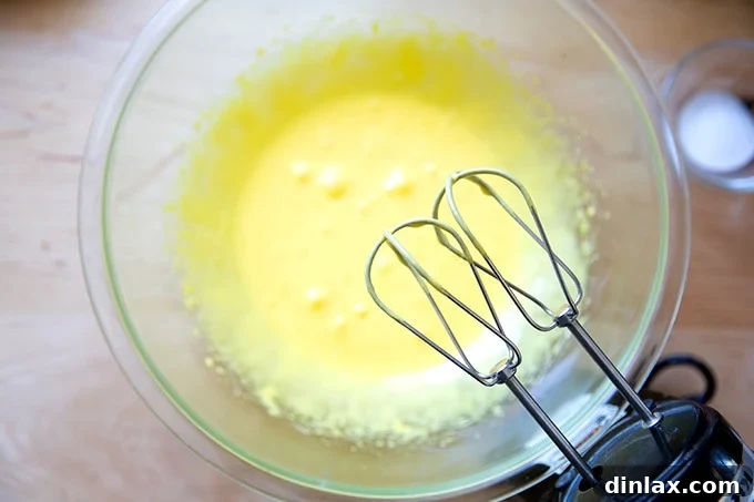 Classic Caprese Flourless Chocolate Almond Torte 7 Beaten egg yolks and sugar, appearing light yellow and thickened to a ribbon-like consistency, ready for the next step.