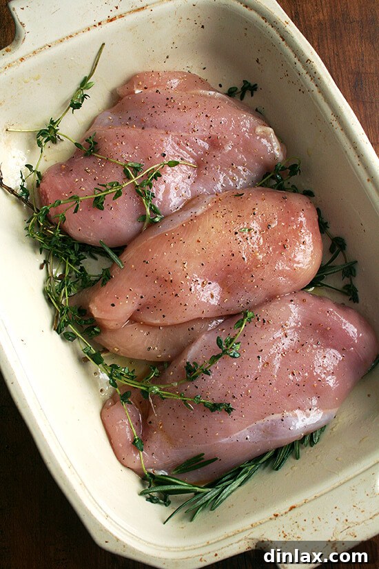 Make-Ahead Lemon & White Wine Chicken Pasta 5 Three boneless, skinless chicken breasts seasoned and arranged in a roasting pan.