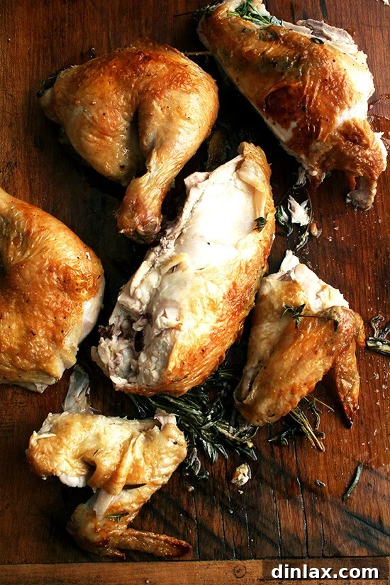 Make-Ahead Lemon & White Wine Chicken Pasta 8 A cooked, spatchcocked chicken, carved into pieces on a wooden board, ready for use in recipes or serving.