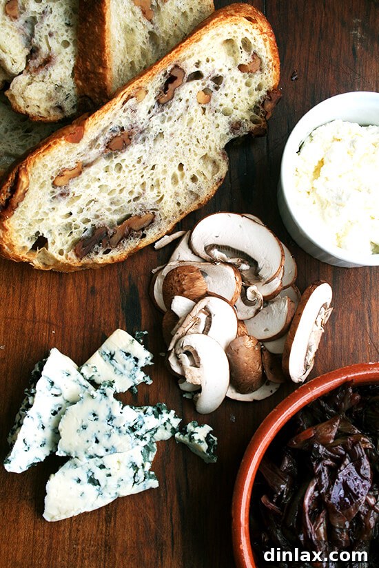 Assortment of fresh ingredients for making tartines: mushrooms, radicchio, bread, olive oil, and cheese.
