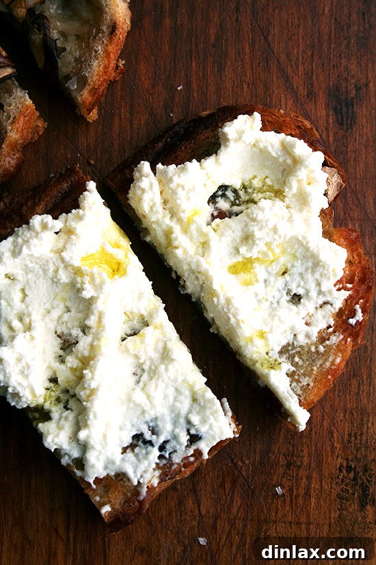 Fresh ricotta tartines, drizzled with olive oil and sprinkled with sea salt, offering a light and creamy bite.