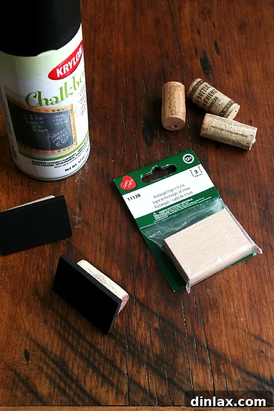 Materials for chalkboard-cork table place cards: chalkboard spray paint, corks, and mini wooden boards.