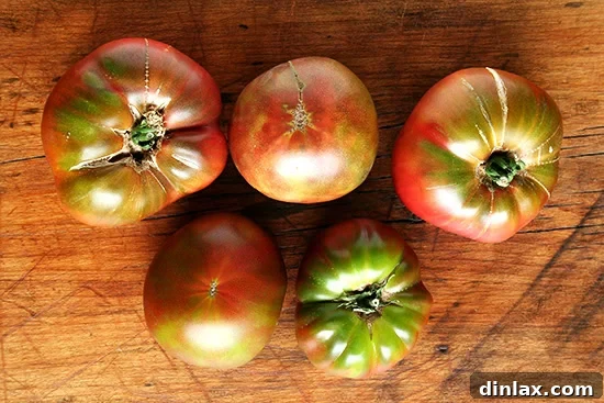 Ripe Cherokee Purple Tomato A close-up of a vibrant Cherokee Purple tomato, showing its unique color and texture, ready for harvest.