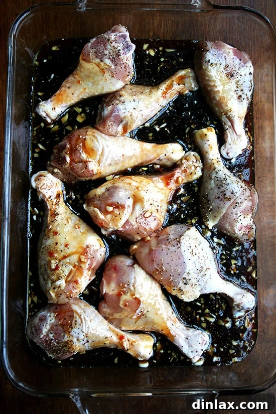 Sticky Honey-Soy Chicken 12 A 9x13-inch baking pan generously filled with chicken drumsticks and honey-soy sauce mixture, ready for the oven.