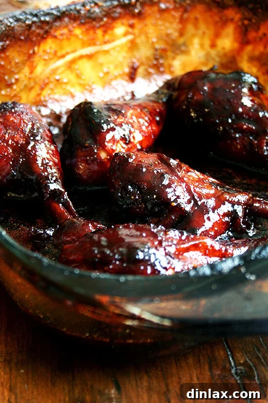 Sticky Honey-Soy Chicken 7 Golden-brown honey-soy chicken drumsticks, freshly out of the oven and resting in the baking dish, ready to be served.
