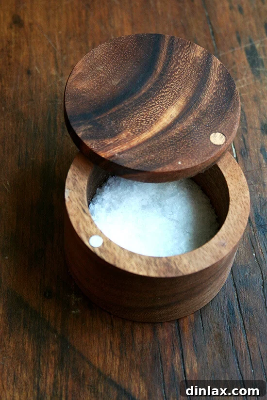 Make the Most of Your Radishes 20 A new acacia wood salt cellar, ideal for storing and easily accessing sea salt, positioned next to a small decorative fish figurine.