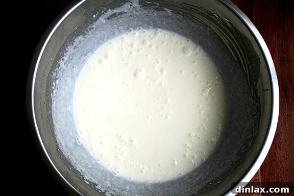 Silken Mascarpone Sorbet 4 Smooth, pale yellow mascarpone sorbet mixture in a large mixing bowl, ready to be transferred to an ice cream maker for churning.
