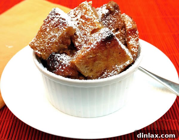 Hearty Pumpkin Bread Pudding, lightly dusted with powdered sugar, in a rustic serving dish.