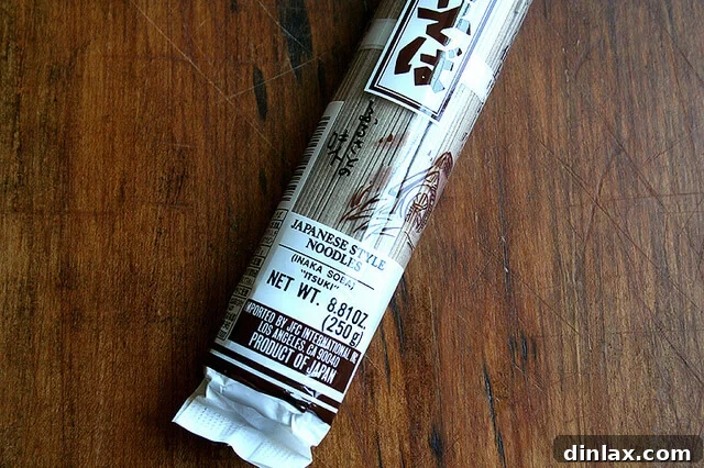A vibrant bowl of cooked soba noodles, ready to be tossed with fresh herbs and marinated tofu.