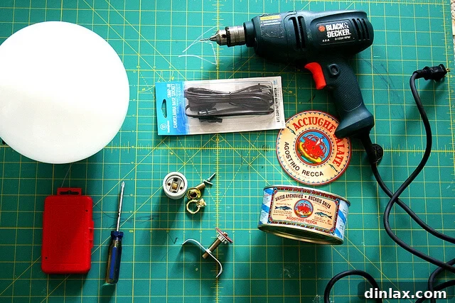 Various tools laid out for the DIY anchovy tin lamp project.