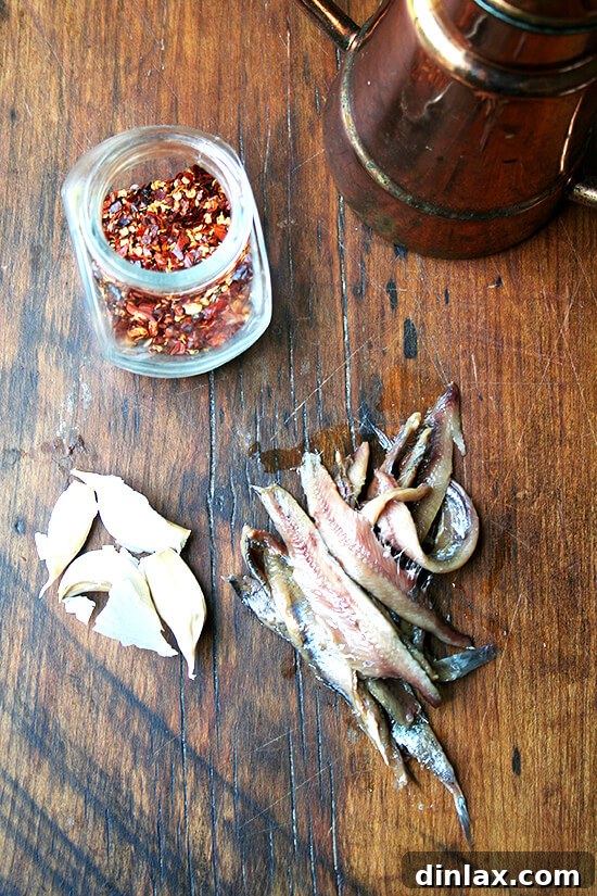 Ingredients for the anchovy vinaigrette laid out on a kitchen counter.