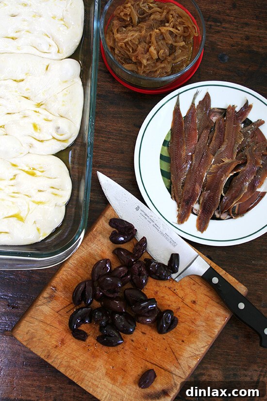 Lahey Pizza Dough Rescue: Pissaladière and Focaccia 6 Pissaladière toppings laid out: caramelized onions, anchovies, olives, and fresh thyme.