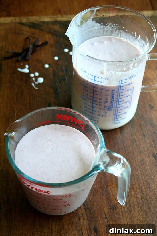 Jammy Rhubarb Ripple Ice Cream 11 The blended rhubarb ice cream base, showcasing its uniform color and smooth consistency, prepared for churning in two liquid measuring cups.