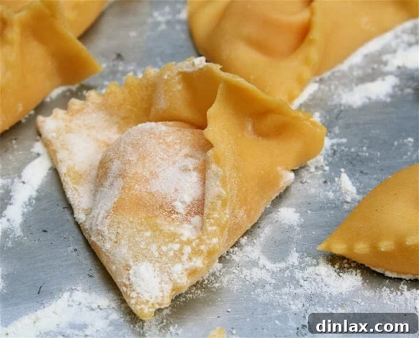This pumpkin ravioli recipe can be made over a few days: Roast the squash and make the filling one day; make the dough and shape the ravioli the next; cook them immediately or freeze them indefinitely. The sage brown butter sauce takes no time to prepare, so having these tasty pillows on hand (frozen) makes for a simple dinner. And I guess they really can't be called ravioli. I'm not sure what shape they are, but they're yummy nonetheless. // alexandracooks.com A perfectly shaped uncooked pumpkin ravioli awaiting its culinary journey.
