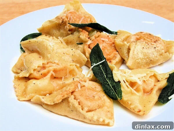 Golden Pumpkin Ravioli Delight 3 A beautifully presented plate of freshly cooked pumpkin ravioli, glistening with sage brown butter sauce and garnished with crisp sage leaves.