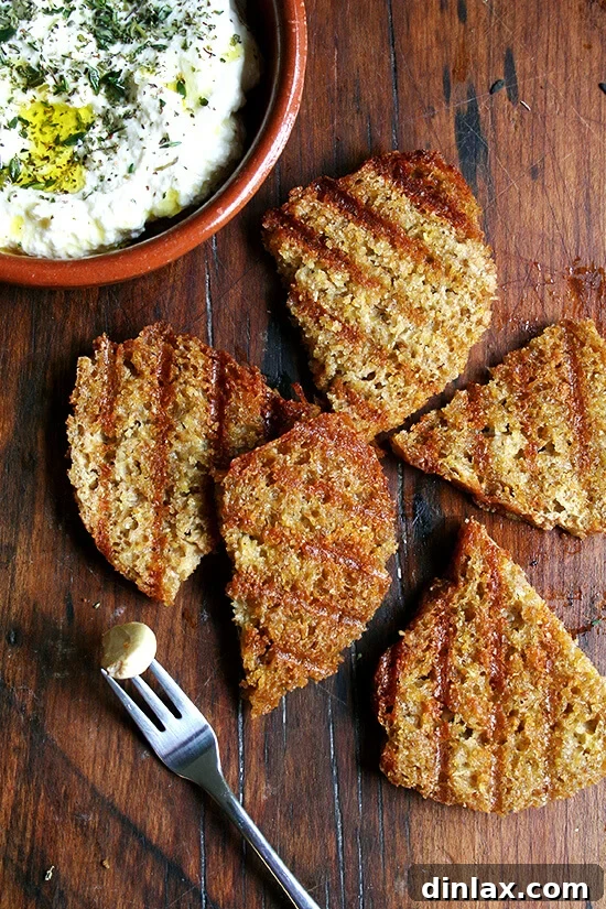 Thyme-Infused Ricotta with Olive Oil and Grilled Sourdough 3 Grilled bread slices next to a bowl of homemade ricotta