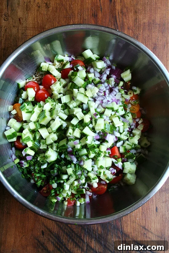 All the fresh ingredients for tabbouleh mixed in a large bowl, ready to be tossed.