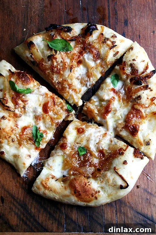 Baking Steel Masterpiece: Margherita & Caramelized Onion Burrata Pizzas 16 A just-baked caramelized onion and burrata pizza, garnished with fresh basil leaves, ready to be enjoyed.