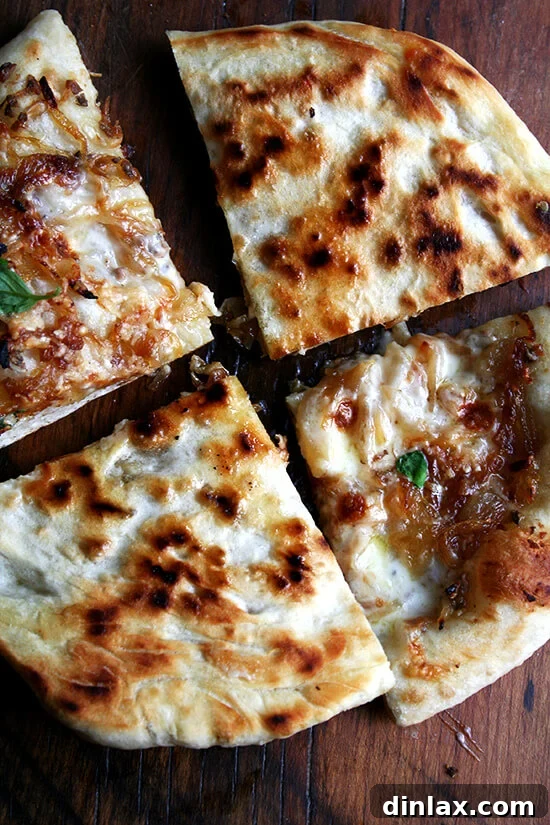 Baking Steel Masterpiece: Margherita & Caramelized Onion Burrata Pizzas 19 The perfectly crisp and speckled undercarriage of a caramelized onion and burrata pizza slice.