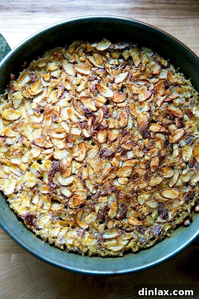 Wholesome Baked Steel Cut Oats 2 A bowl of freshly baked steel cut oatmeal garnished with almonds and fresh berries.