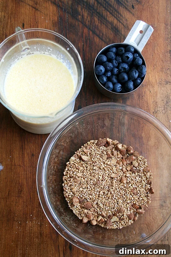Wholesome Baked Steel Cut Oats 4 Separate bowls containing the wet milk mixture, the dry oat mixture, and fresh berries, ready to be combined for the baked steel cut oatmeal.