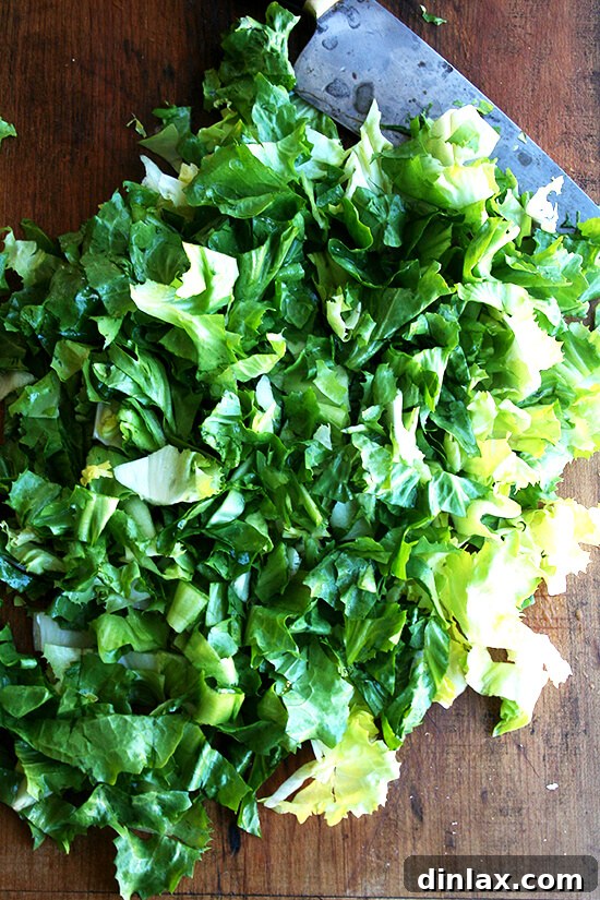 Hearty Italian Sausage, Escarole, and White Bean Soup 11 A pile of neatly chopped escarole leaves, prepared for cooking and adding to the soup.