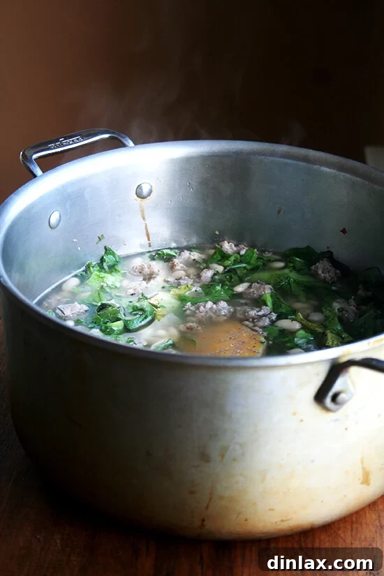 Hearty Italian Sausage, Escarole, and White Bean Soup 15 A large pot brimming with white bean, escarole, and sausage soup, gently simmering to perfection.