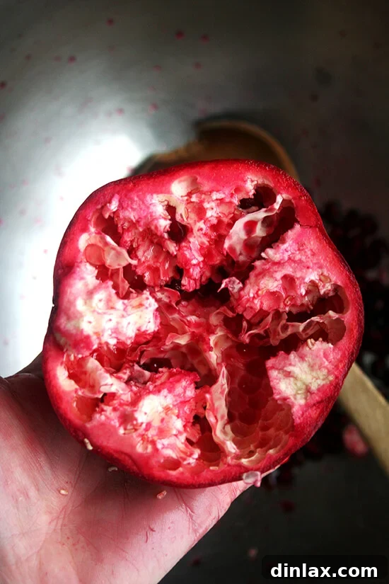A pomegranate halved, ready for seeding.
