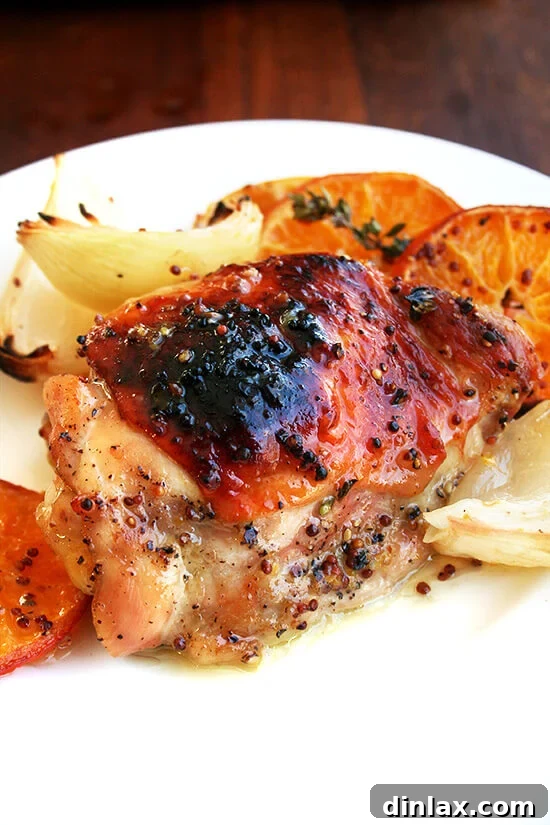 Clementine-Kissed Roast Chicken 9 Roast chicken and clementines beautifully arranged on a plate, ready to be served.