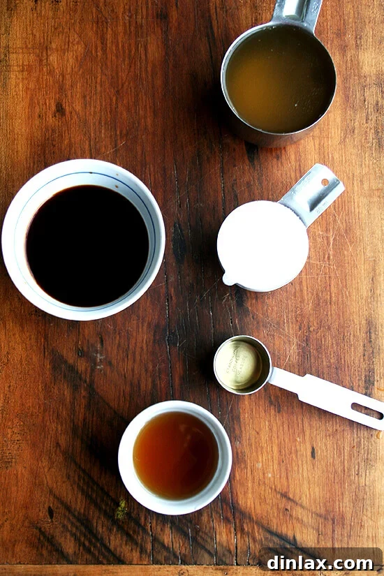 Essential ingredients for homemade teriyaki sauce: chicken stock, soy sauce, sugar, mirin, and sake.