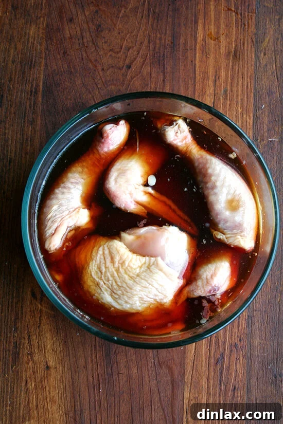 Chicken marinating in teriyaki sauce for enhanced flavor.