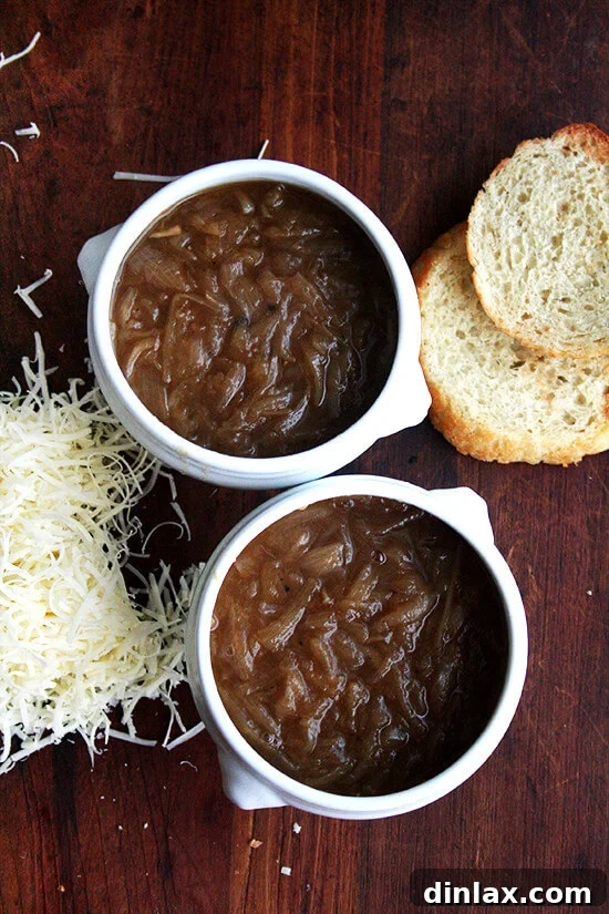 Two bowls of French onion soup, freshly poured and ready for their bread and cheese topping.