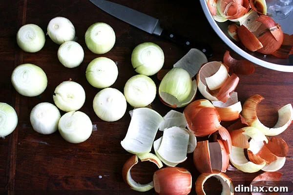 A collection of peeled onions neatly arranged on a board.