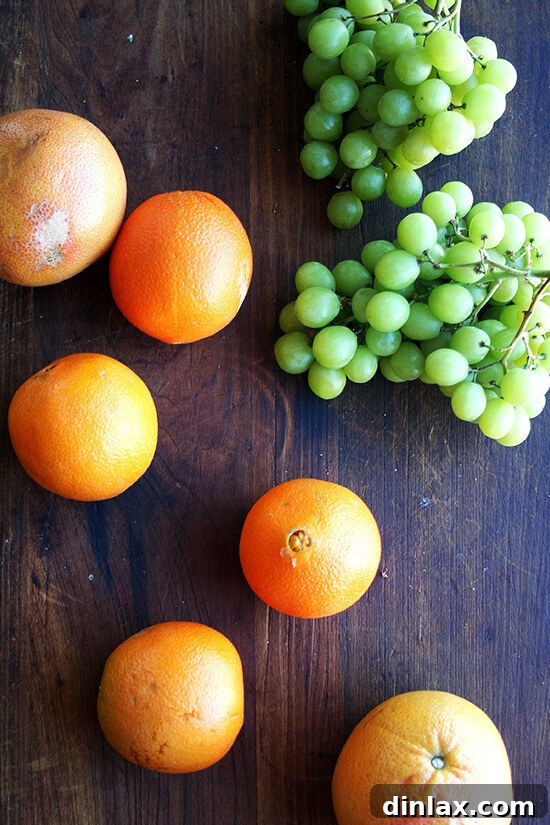 Bright Citrus and Green Grape Compote 2 Freshly peeled citrus segments and green grapes, ready to be combined into a vibrant compote.