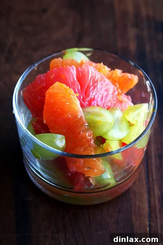 Delicious orange, grapefruit, and green grape compote A close-up shot of the finished compote, showcasing the glistening fruit and vibrant colors.