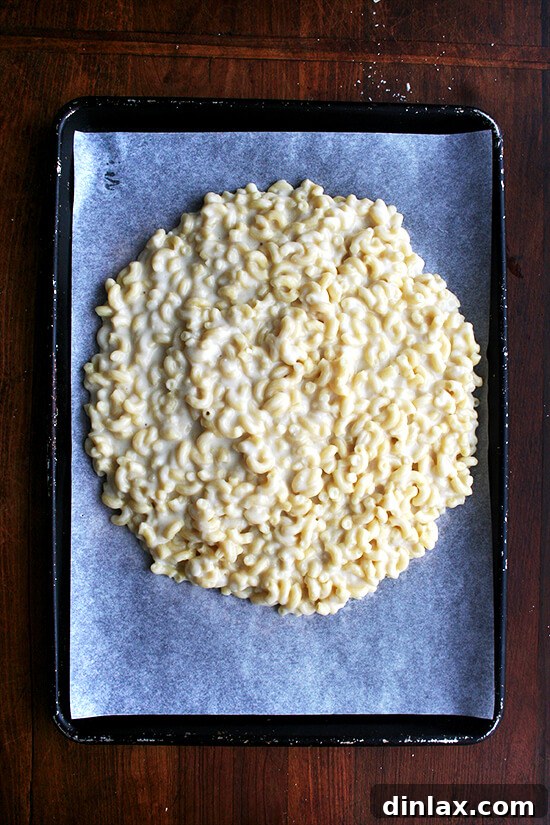 Golden Crispy Macaroni Cheese Bake 8 Spreading the mac n cheese mixture evenly onto a parchment-lined sheet pan