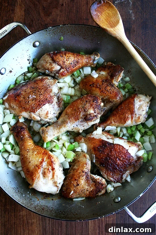 The Iconic Canal House Chicken and Rice 5 Adding diced celery and onion to the pot with the already browned chicken, creating an aromatic foundation for the Canal House Chicken and Rice.