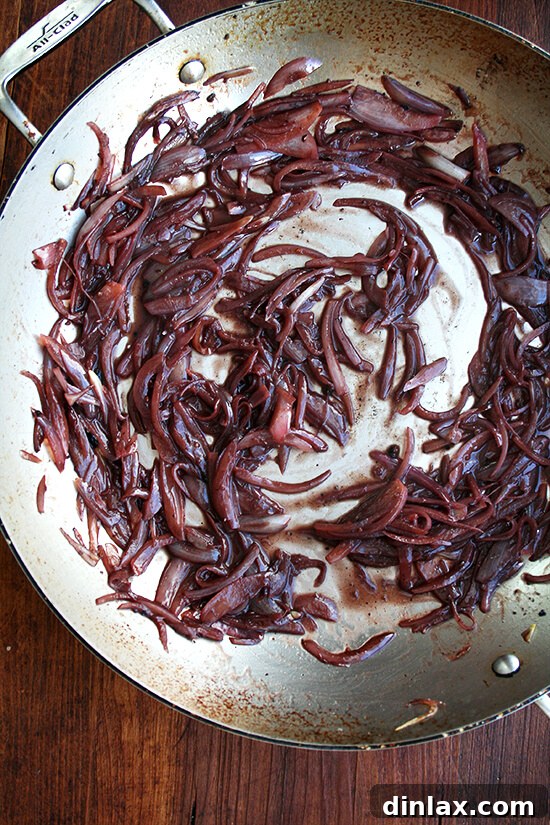 Softened, golden shallots in the pan, ready for vinegar and red wine.