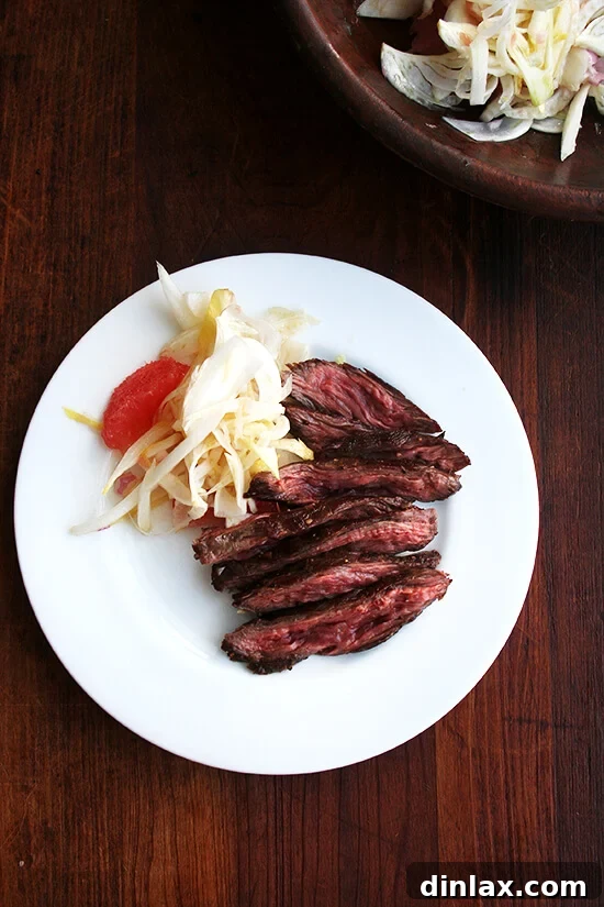 Beautifully sliced steak served alongside a refreshing endive, fennel, and grapefruit salad.