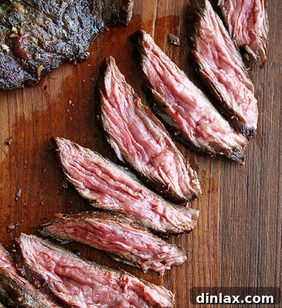 Perfectly cooked skirt steak with shallots on a plate.