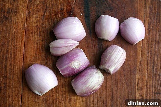 Peeled and trimmed shallots, prepared for slicing.