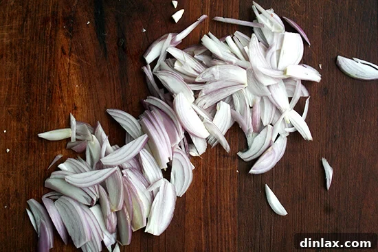 Thinly sliced shallots, perfect for the red wine reduction sauce.
