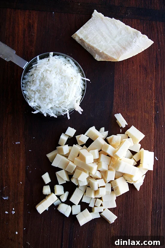 A bowl of freshly grated cheese, likely Parmigiano Reggiano, ready for the gratin.