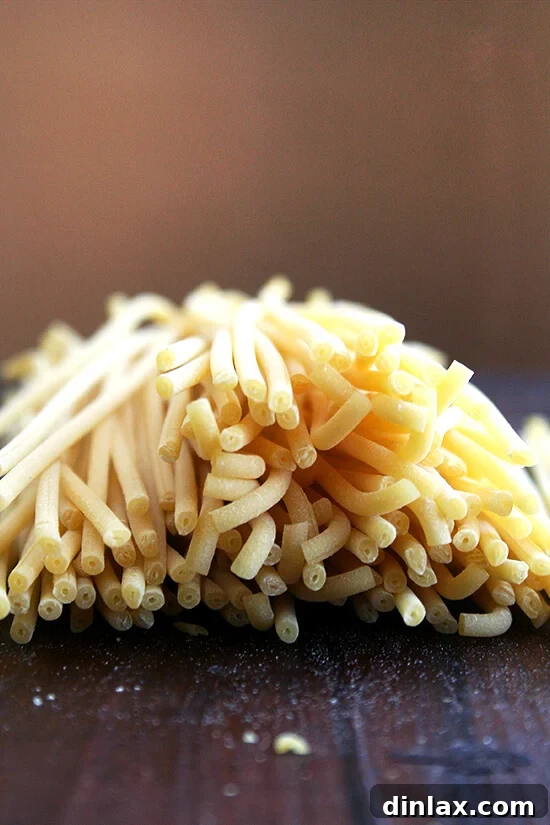 A generous serving of bucatini pasta coated in the glossy butter-roasted tomato sauce, garnished with fresh herbs.