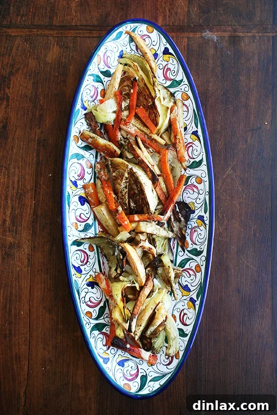 A vibrant platter of perfectly roasted vegetables, including cauliflower, broccoli, carrots, and parsnips, drizzled with a rich tahini, olive oil, lemon juice, and garlic dressing, finished with za'atar.