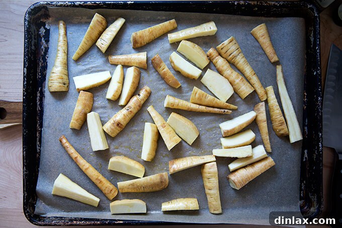 Roasted Chili-Honey Parsnips 5 A sheet pan with freshly cleaned and uniformly cut, un-roasted parsnips, seasoned with olive oil, salt, and pepper, ready to enter the hot oven.