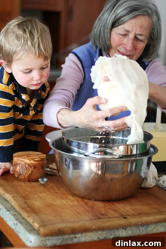 Squeezing cheesecloth to extract buttermilk from butter