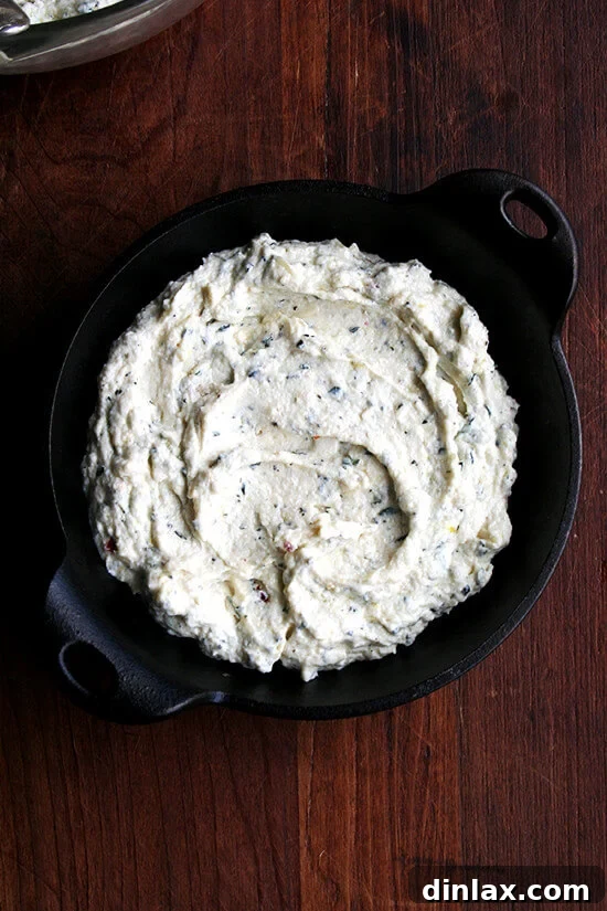 A baking dish filled with the mixed ricotta mixture, drizzled with olive oil, and ready to go into the oven.