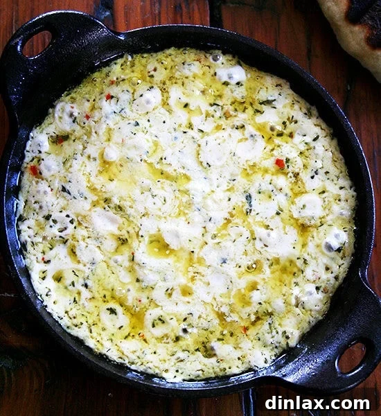 A cast iron skillet filled with baked ricotta.