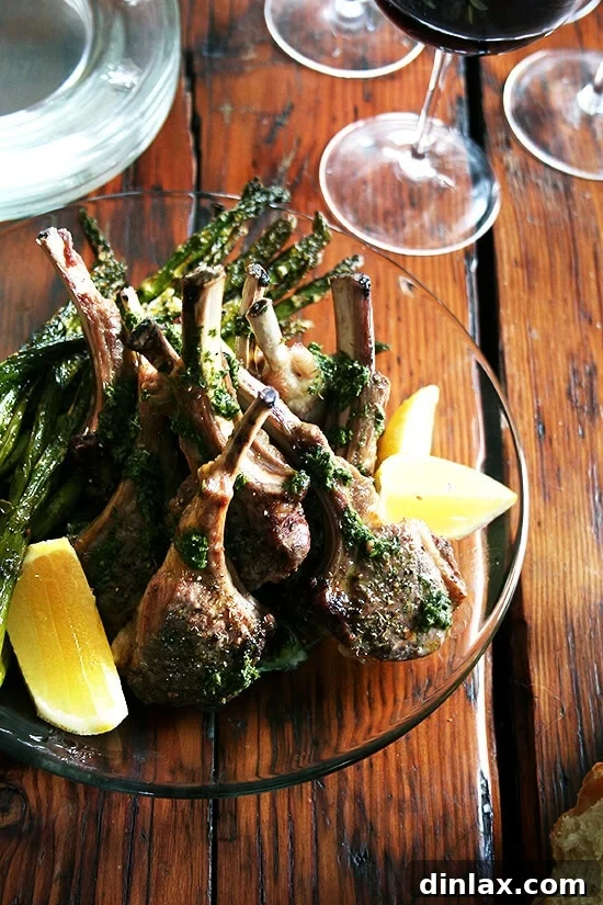 A vibrant platter of perfectly broiled lamb chops generously drizzled with fresh mint sauce, ready to be served.